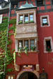 Half-timbered & stone Winstub show former German ownership of Alsace. Riquewihr, France.