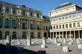 Daniel Buren's Columns art installation in Grand court at Palais Royale with row of round windows of Comedie Français theater at top right. Paris, France.