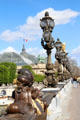 Row of Art Nouveau lamps on Pont Alexandre III with Grand Palais beyond. Paris, France.