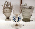 Venetian glass flask , drinking glass on stem decorated with wings & glass bucket at Museum of Decorative Arts. Paris, France.