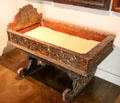 Rocking cradle with carved sides at Museum of Decorative Arts. Paris, France.