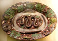 Glazed earthenware platter with moulded snake, fish & other creatures at Sèvres National Ceramic Museum. Paris, France.