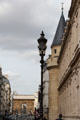 Rue Saint-Martin facade of corner tower of Arts et Metiers Museum with Porte Saint-Martin arch beyond. Paris, France.