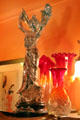 Art Nouveau metal statuette plus colored glass vases at Maxim's Art Nouveau Collection 1900. Paris, France.