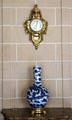 Parisian wall clock & Chinese dragon vase at Nissim de Camondo Museum. Paris, France.