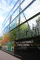 Green glass wall signage at Musée du quai Branly. Paris, France.