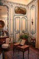 Ornate blue wall filigree from demolished mansion & period furniture in Blue Salon Louis XV at Carnavalet Museum. Paris, France.