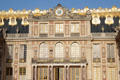 Clock & facade of Marble Court of first Versailles Palace. Versailles, France.