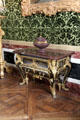 Stone-topped table with marquetry drawers & metal fittings in salon of abundance at Versailles Palace. Versailles, France.