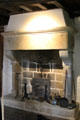 Small fireplace with heat reflecting iron plate in Cartier's bedroom at Jacques Cartier Manor House Museum. St Malo, France.