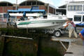 Putting power boat onto lift cradle to lower craft into Dieppe harbor. Dieppe, France.