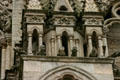 Gargoyles looking out from gallery on Amiens Cathedral. Amiens, France.