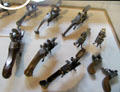 Percussion lighters from France used same mechanism as flintlocks rifles to ignite fires at Wrought Iron Museum. Rouen, France.