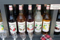 Fruit syrups in shop window on Place St Croix. France.