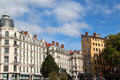 Heritage buildings along Quai Saint-Vincent including Fresque des Lyonnais mural. Lyon, France.