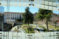 Landscaped courtyard park seen through window of Musée de la Romanité. Nimes, France.