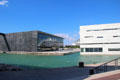 Cruise ship reflects off black MuCEM museum & white Villa Méditerranée. Marseille, France