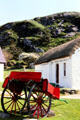 Traditional Irish wagon with fenders for passengers to sit sideways parked in Folk Village, Glencolumbkille. Ireland