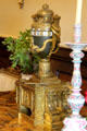 Horizontal cylindrical dial clock in shape of urn wrapped with snakes at Russborough House. Ireland.