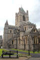 East end of Christ Church Cathedral with sculpture of man sleeping on bench. Dublin, Ireland.