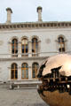 Sphere Within Sphere sculpture by Arnaldo Pomodoro & Museum Building at Trinity College. Dublin, Ireland.
