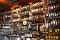 Liquor bottles crowded on shelves at Dick Mack's Pub in Dingle. Dingle, Ireland.