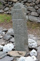 Ancient stone with cross at Gallarus Oratory on Dingle Peninsula. Ireland.