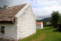 Stone & thatched roof dwelling at Quille's farm at Muckross Traditional Farms in Killarney National Park. Killarney, Ireland.