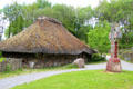 Replica of Irish Monastery building & high cross at Irish National Heritage Park. Ireland.
