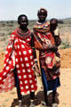 Samburu women in traditional colorful sarong dress & layers of necklaces. Kenya.