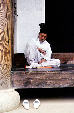 Elderly man resting on porch of Korean style house in folk village, Seoul. South Korea.