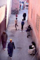 Narrow street with pedestrians. Marrakesh, Morocco.