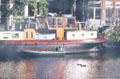 Houseboat on Zwanenburgwal near opera. Amsterdam, Netherlands.