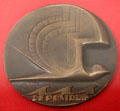 Stylized pigeon over ocean waves medal commemorating first postal flight from the Netherlands to Dutch East Indies by Van der Hoef at Teylers Museum. Haarlem, Netherlands.
