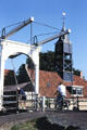 Bicyclist crosses a lift bridge. Hindeloopen, Netherlands