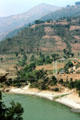 Suspension bridge across mountain river seen from road to Katmandu. Nepal