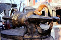 Monkey sits under thunderbolt Tibetan religious symbol in Swayambhunath Buddhist Temple in Katmandu. Nepal.