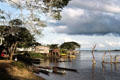 Canoes and houses on the shore of Sepik River at Angoram. Papua New Guinea.