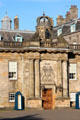 Holyrood Palace wing built under Charles II with crowned clock tower over doorway. Edinburgh, Scotland.
