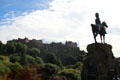 Royal Scots Greys Monument silhouetted against Edinburgh Castle. Edinburgh, Scotland.