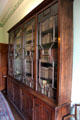 Glass fronted mahogany bookcase in parlour at Georgian House museum. Edinburgh, Scotland.