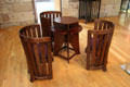 Round-back chairs & round two-level domino table by Charles Rennie Mackintosh for Miss Cranston's Tearooms at The Lighthouse. Glasgow, Scotland.