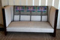 Upholstered settle by C.R. Mackintosh with replicas of antimacassars embroidered by Margaret Mackintosh in drawing room at Hill House. Helensburgh, Scotland.