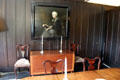 Portrait over chest & side chairs in dining room at Hill House. Helensburgh, Scotland.