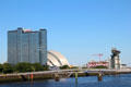 Clyde River with footbridge to Pacific Quay, Crowne Plaza tower, Armadillo & dockyard crane. Glasgow, Scotland.