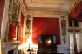 Gilt over mantel mirror & mahogany bedside cupboard both attrib. James Cullen surrounded by Rococo-style wall plaques in State Bedchamber at Hopetoun House. Queensferry, Scotland.