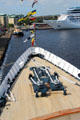 Bow of Royal Yacht Britannia with cruise ship beyond in Leith harbor. Edinburgh, Scotland.