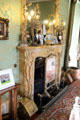 Large drawing room fireplace from Siena supporting elaborate lamps at Thirlestane Castle. Scotland.