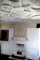 Tartan bedroom sculpted plaster ceiling & fireplace mantle with Forbes crest at Craigievar Castle. Alford, Scotland.