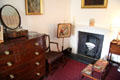 Fireplace, chest of drawers & step stool to climb to bed in Pink Room at Castle Fraser. Aberdeenshire, Scotland.